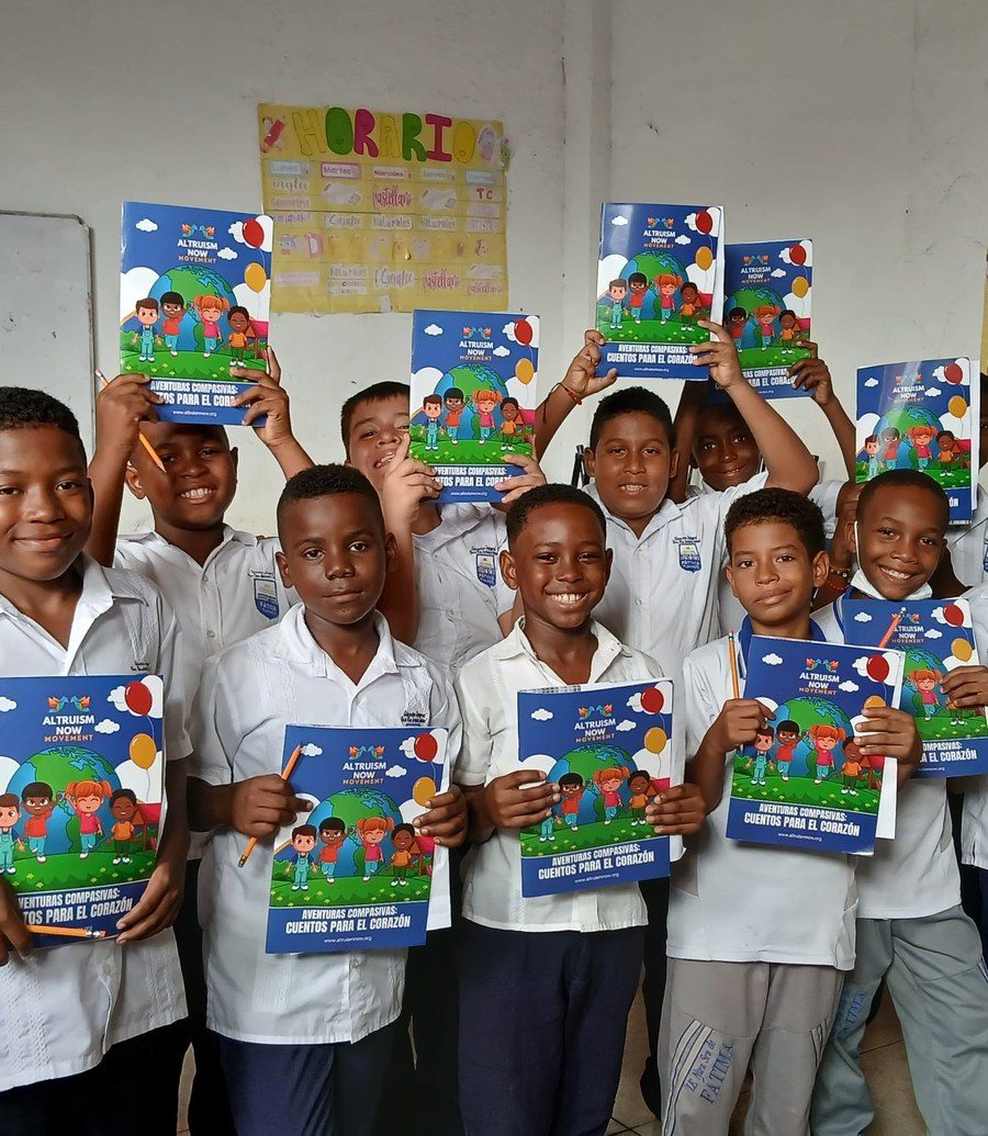 Children holding their Altruism Now activity books